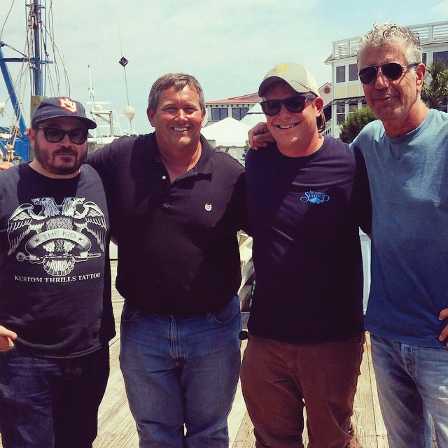 In 2015, Abundant Seafood was featured on the late Anthony Bourdain’s Parts Unknown. Here, chef Sean Brock, Mark, chef Aaron Swersky and Bourdain pose at Geechie Dock.