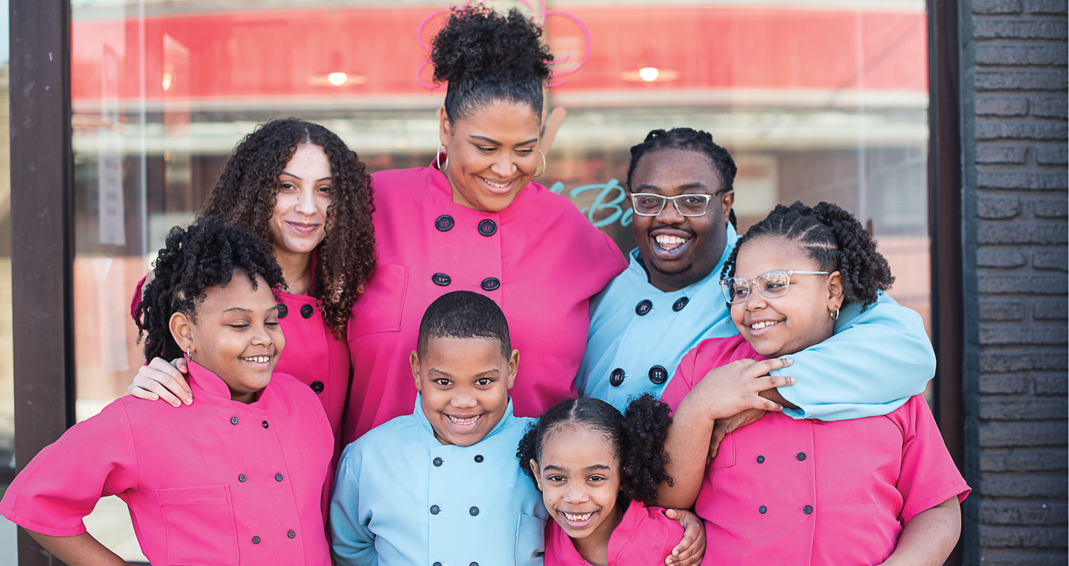 The Brown family in front of the bakeshop they opened on Reynolds Avenue in January.