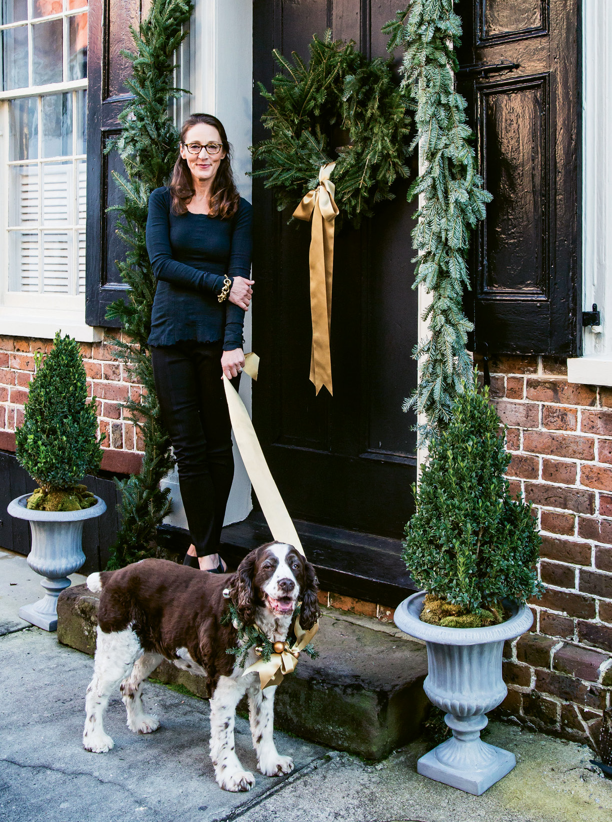 WELCOME HOME: Tara and her English springer spaniel, Georgia, greet guests as they arrive to their Tradd Street home.