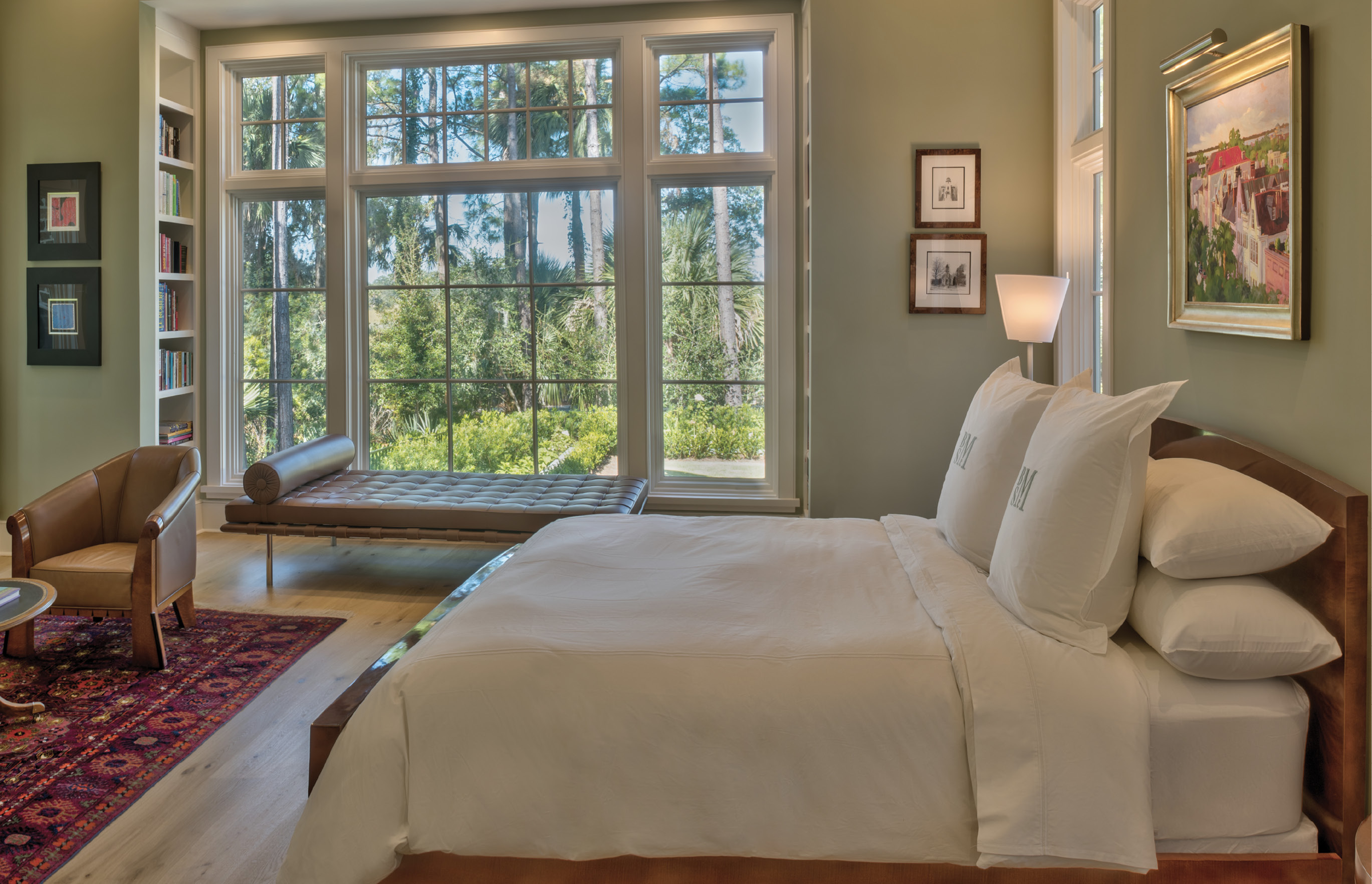 TRANQUIL RETREAT: Walls throughout the home are white, except for the soothing seafoam green in the master suite. With windows on three sides, the master gets plenty of soft light; “the beauty when the sun is coming up is very special,” the wife says.