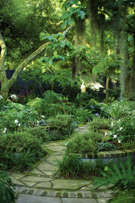 Nice Curves: The circular raised garden was built from six-inch concrete masonry blocks, smooth stucco, and brick and planted with weeping rosemary, salvia, and mandevilla vine.