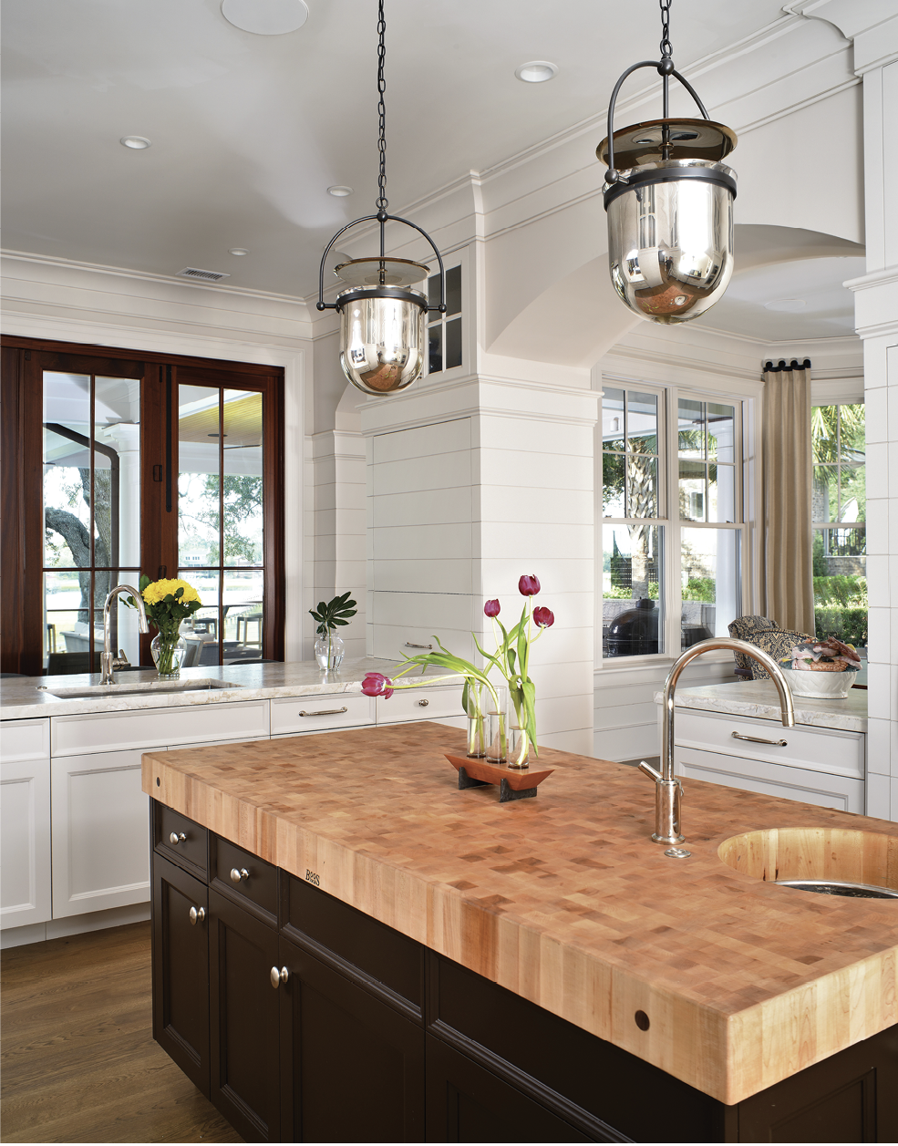 The kitchen features a Boos Block island and industrial-style pendant lights from Urban Electric.