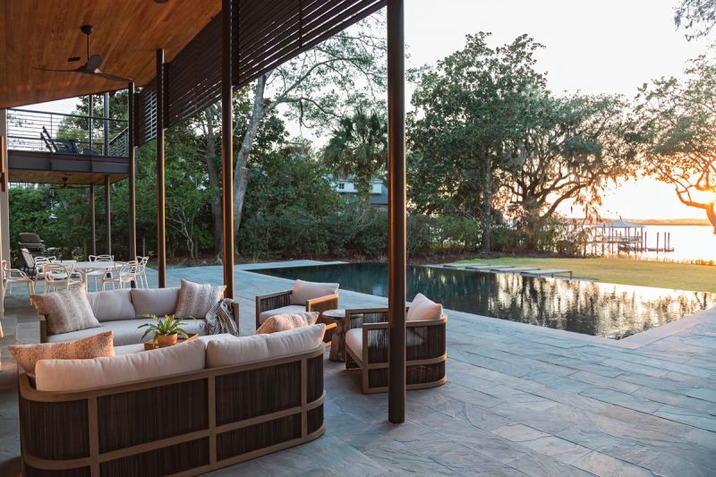 “Capri” teak sofas and chairs from Restoration Hardware on the expansive bluestone patio are just one of many spots to take in the view.