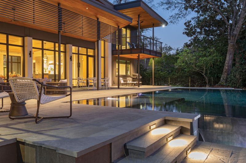 Expanses of glass in steel-framed windows and a mono-slope roof that rises to 17 feet allow this James Island house, overlooking the Stono River, to capture epic sunsets.