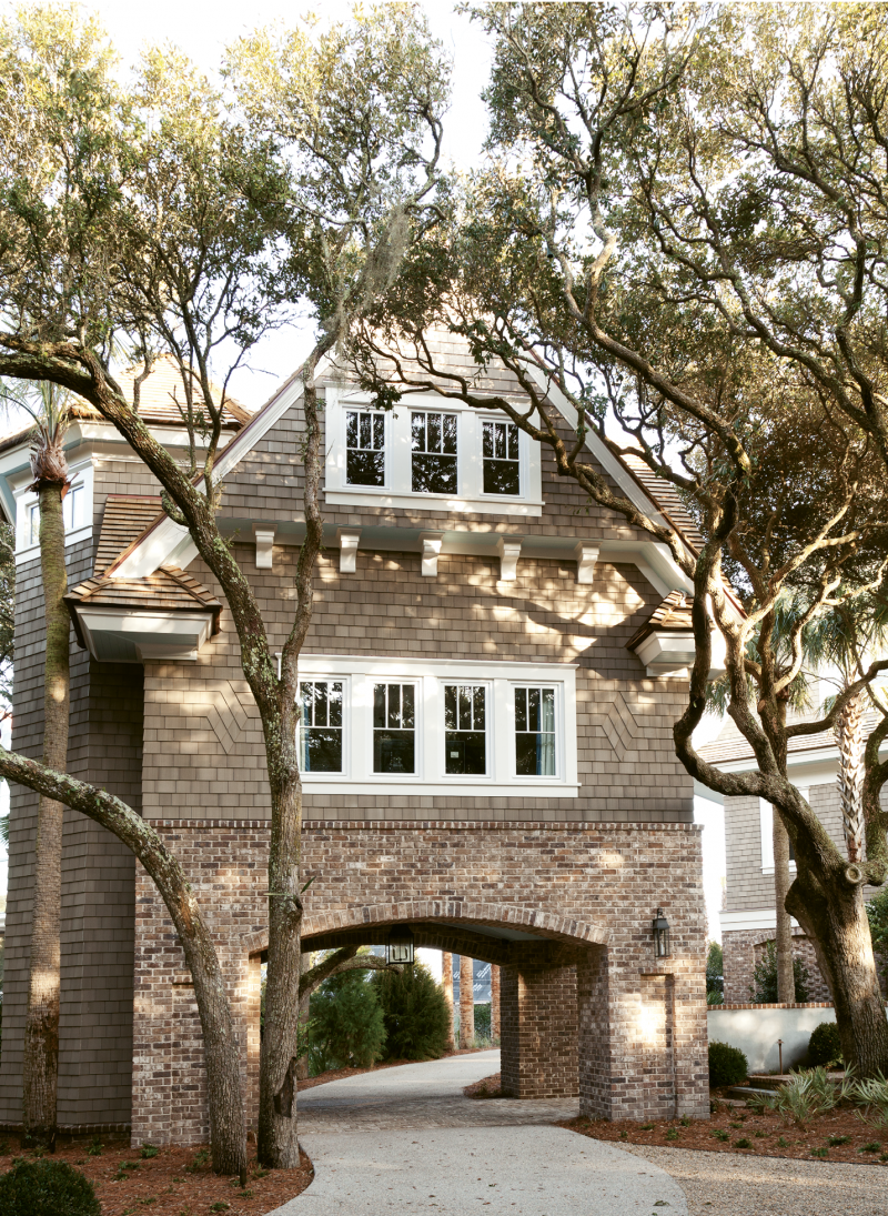 The driveway wends through a maritime forest of wind-swept oaks and under the guest cottage, which includes a kitchenette.