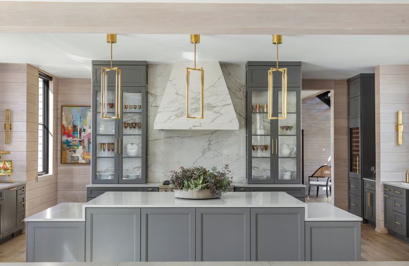 The cabinetry continues into the kitchen, showcasing the custom porcelain range hood and quartz countertops.