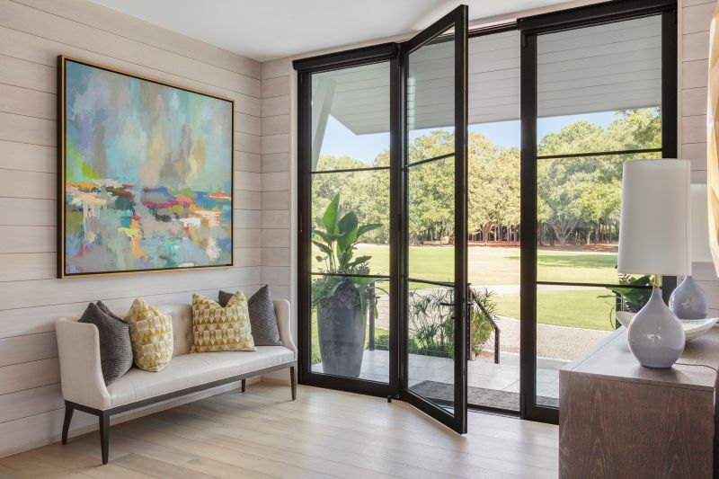 Neutral tones allow the home’s modern artwork, such as this Amy Dixon piece from Hagan Fine Art in the entryway, to pop from the whitewashed oak walls.