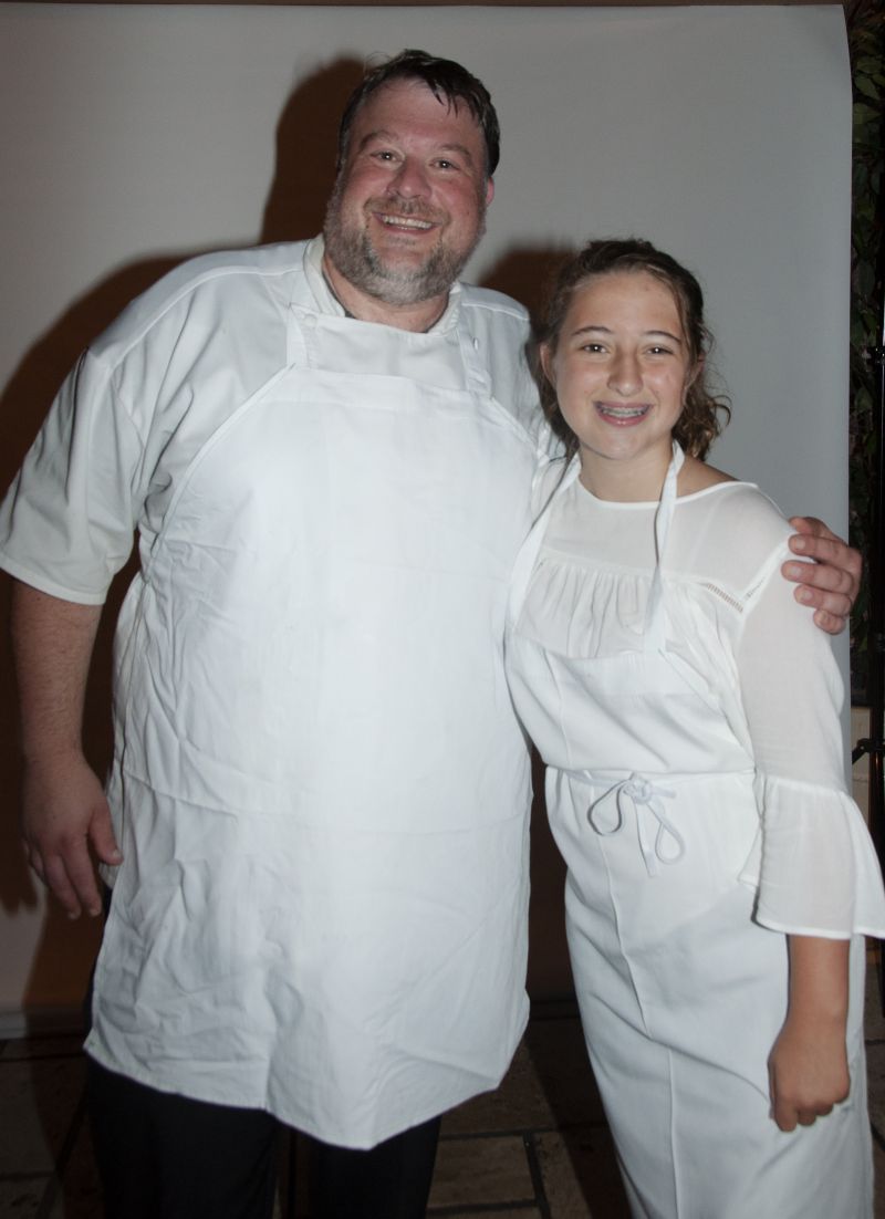 Big Chef Richard Plaistowe of Halls Management Group with Little Chef Isabella Hurd after presenting their raspberry dessert.