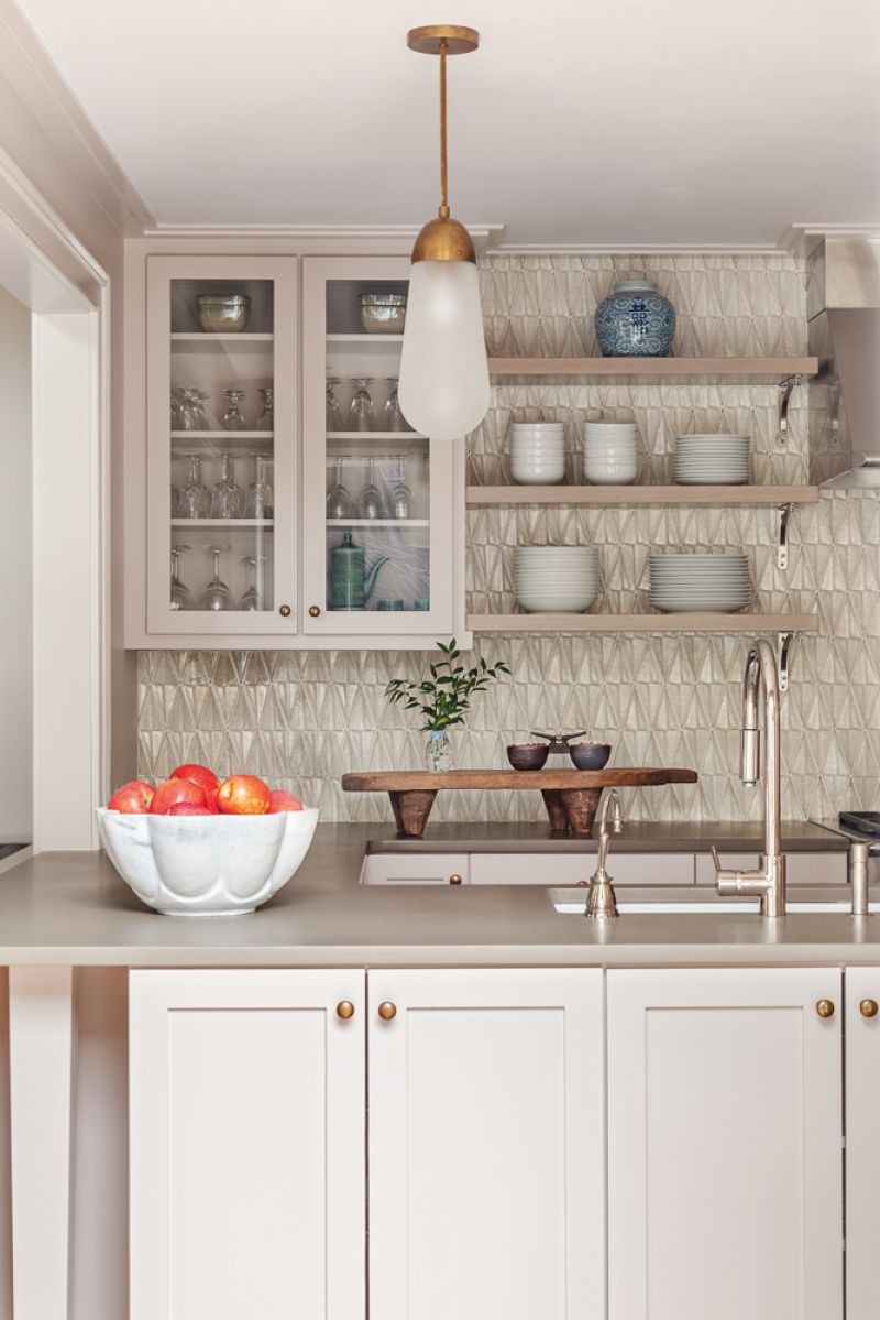 In the kitchen, upper cabinets with glass fronts mix with open shelving.