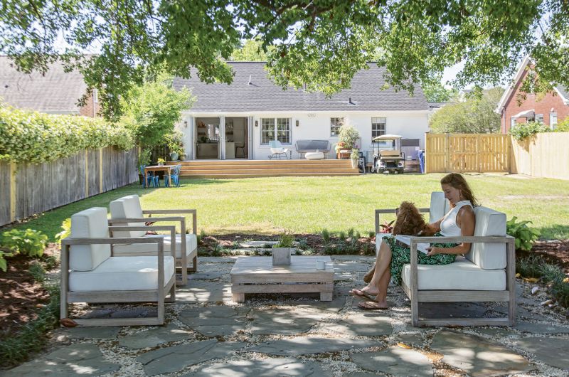 OUTDOOR OASIS: Two sets of French doors and a sprawling wooden deck add appeal to the rear of the home. But Rachel’s work out back has just begun. “I’m going to have big garden beds on both sides of the yard and plant more trees,” she says. “Then dreamland is to have a pool right in line with the patio.”