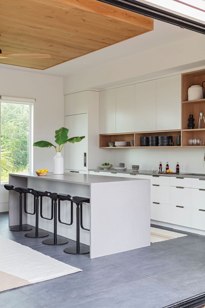 The open plan incorporates a kitchen area and the living room, with a ceiling accent that mimics the wood theme of the main house.