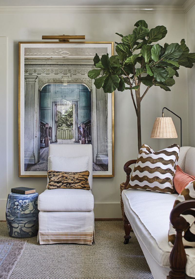 In the living room, Cooper arranged a Mark Sikes slipper chair and 19th-century settee (the latter of which serves as the seat of choice for the couple’s cockapoo Harper) to create a secondary sitting nook. Anne Jervey Rhett’s portrait of Drayton Hall adds depth and intrigue to the space. “I think it turned out great,” says Kruse, who accompanied Anne—a friend of theirs—on the commissioned shoot.