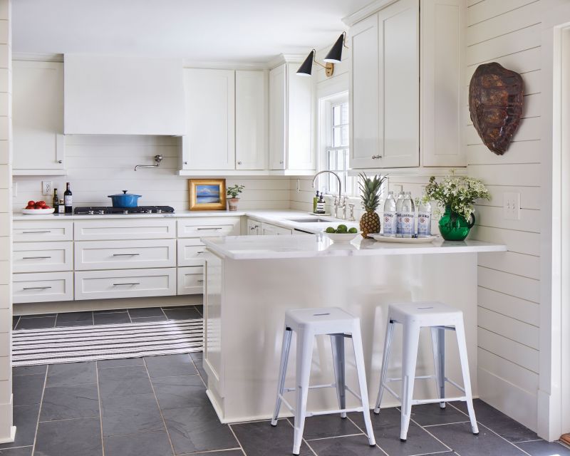 Bright Spot: With white shiplap walls, cabinets, and plaster hood, the home’s kitchen is a calm, blank slate. “It’s nice to have a space that sort of gives you a break and is more about function—where you can focus on the task of preparing a meal,” says Hewlette.