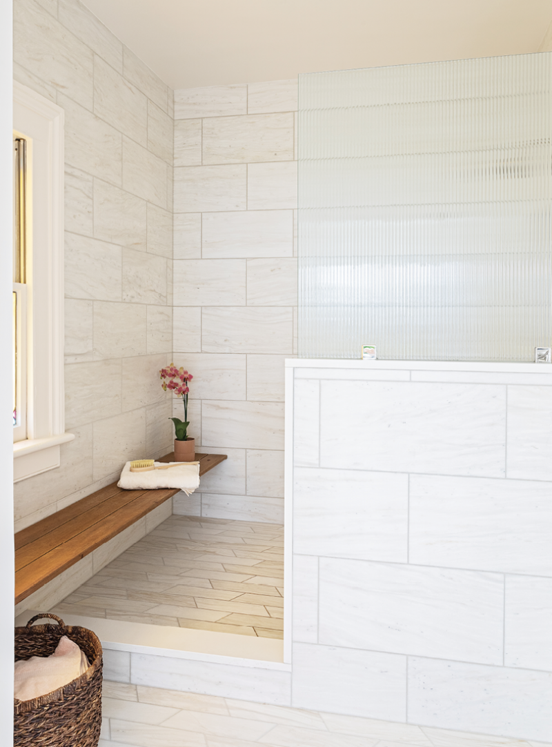 Neutral Territory: A mix of textures, scale, and tone in the tile make this long, lean en-suite bathroom an elegant retreat.