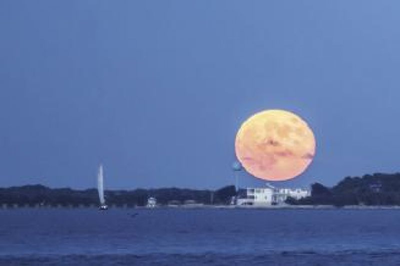 A stunning blue moon rises over a Summer Series race.