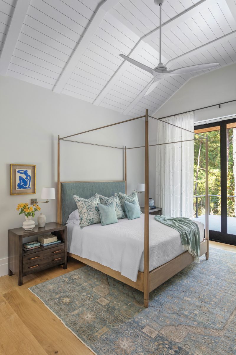 The adjoining bedroom suite has a serene color palette in soft blues and whites.