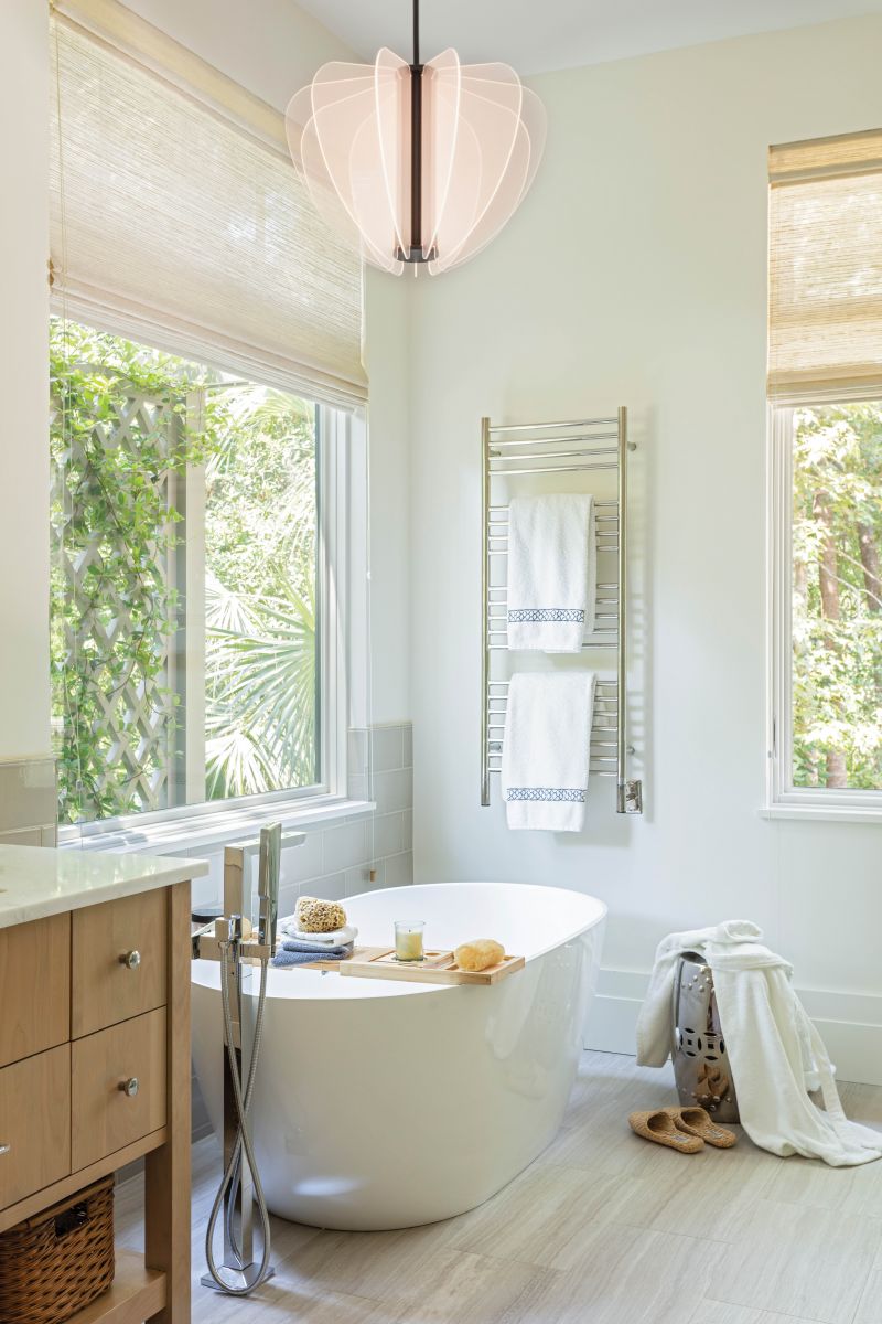 A luxurious soaking tub surrounded by views of nature completes the soothing suite.
