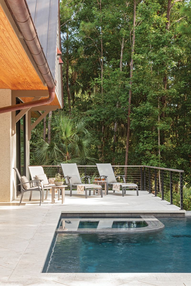 Overhanging gables in the rear of the home provide shelter, while a luxurious infinity pool is the perfect spot for grandkids to play.