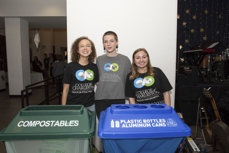 Harmony Baggett, Mikayla Drost, and Brynn Smith with C of C&#039;s Office of Sustainability advise guests on proper recycling practices.