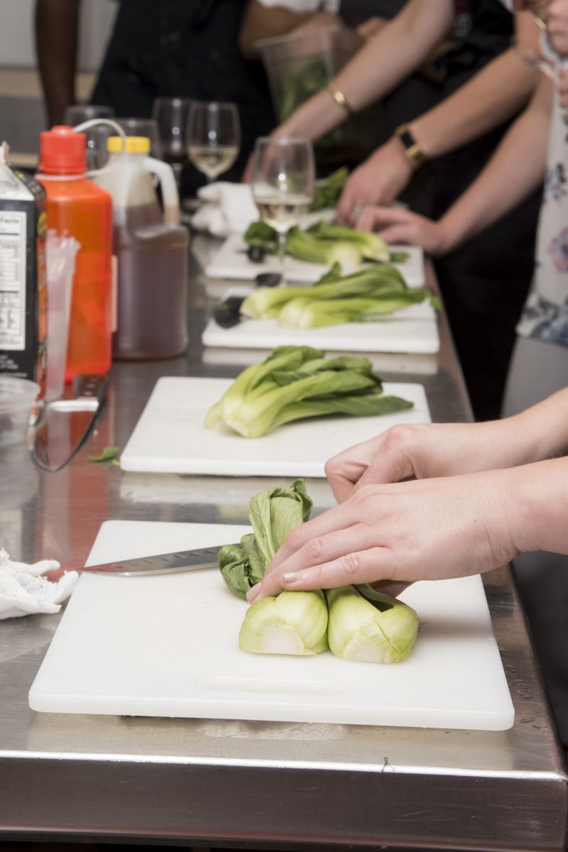 Club members chop the baby bok choy for miso salmon.