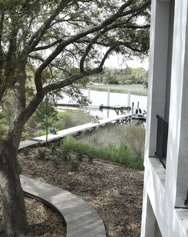 A winding deck leads down to a deep-water dock, where the family often retreats to explore the creek.