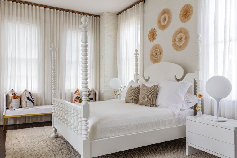 “When Ghislaine asked what I wanted our bedroom to feel like, I simply said, ‘a resort,’” notes Phoebe, who loves the peaceful creams and soft whites. A collage of woven medallions from Mexico add texture, while a bench from their time in San Miguel de Allende serves as a window seat.