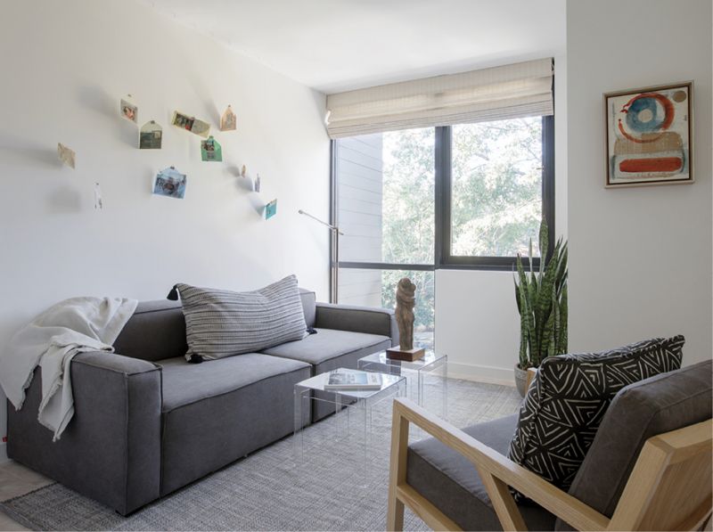 Upstairs, an installation by Celeste Caldwell adorns a wall of a guest bedroom/sitting room with a modular sofa from Gus* Modern.