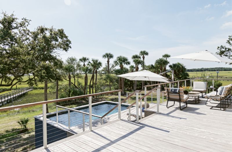 DECKED OUT: The spacious hardwood deck, built of dense and durable Garapa from Brazil, hosts an outdoor sitting room with furnishings from Four Hands and Cane-line of Denmark, as well as a small breakfast bar built into the galvanized steel and wood railings just outside the kitchen.