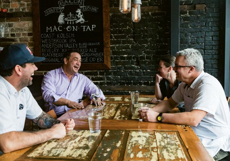 Palmer catches up with his team at The Macintosh, including (left to right) executive chef Jacob Huder, general manager Julie Hennigan, and chef-partner Jeremiah Bacon. As a sober person working in the restaurant business, Palmer loves what he does, and it shows. As far as his beverages of choice, he says, “Sparkling water, of course, but I love the new trend of nonalcoholic cocktails. I’m so glad the industry is finally recognizing that sober people like to drink fun things too. And, by the way, we are happy to pay for them!”