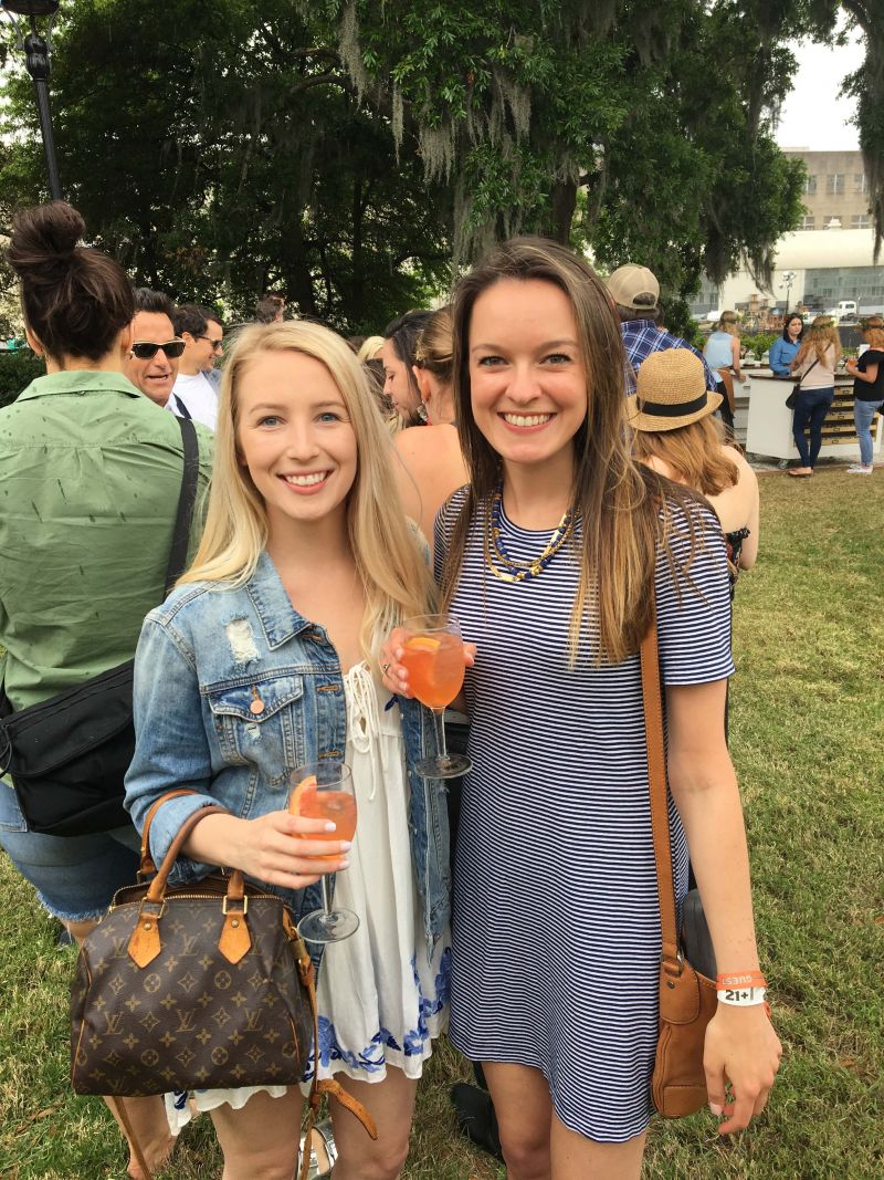 Anne Goforth and Therese Spaseff enjoy cocktails on the lawn.