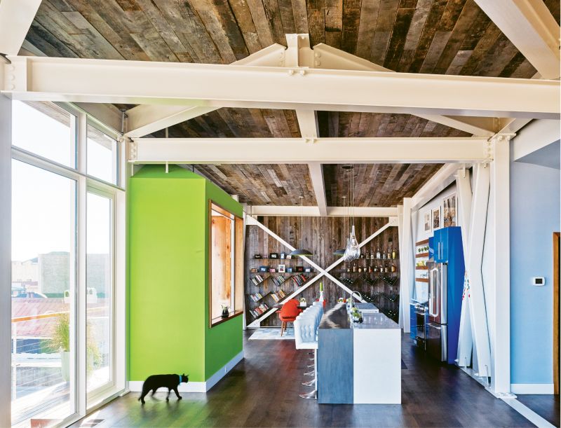 Yessian gravitates toward bright colors. He painted an accent wall in Sherwin Williams’s “Outrageous Green;” the same bold hue graces the underside of the dome lights above the dining table. Made by furniture designer Ben K. Mickus and sourced on Etsy, the pendants are fashioned from repurposed carbon-steel woks.