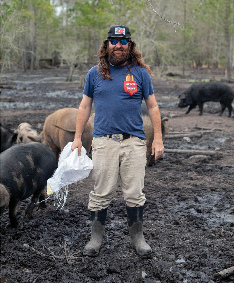 Jackson at his farm, empty feed bag in hand