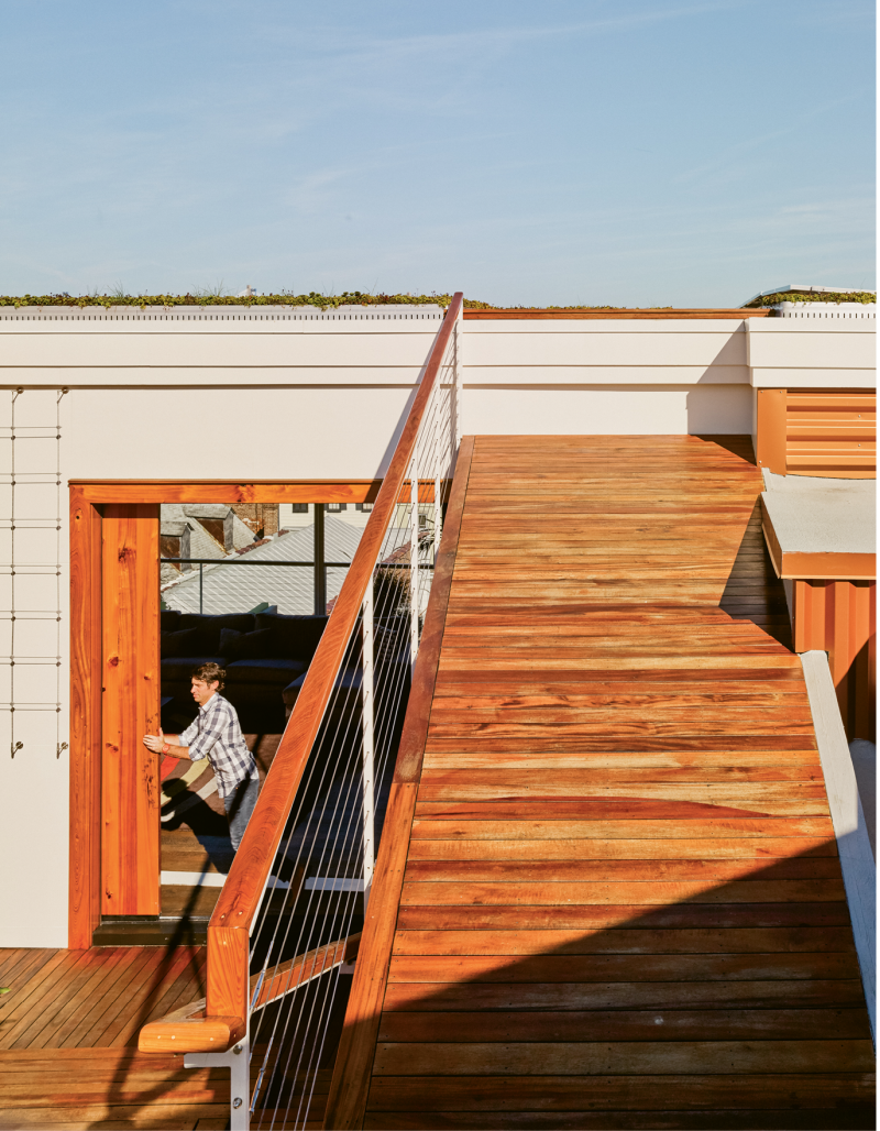 Sliding barn doors hewn from reclaimed river cypress can be left open to blend inside and outside living spaces.