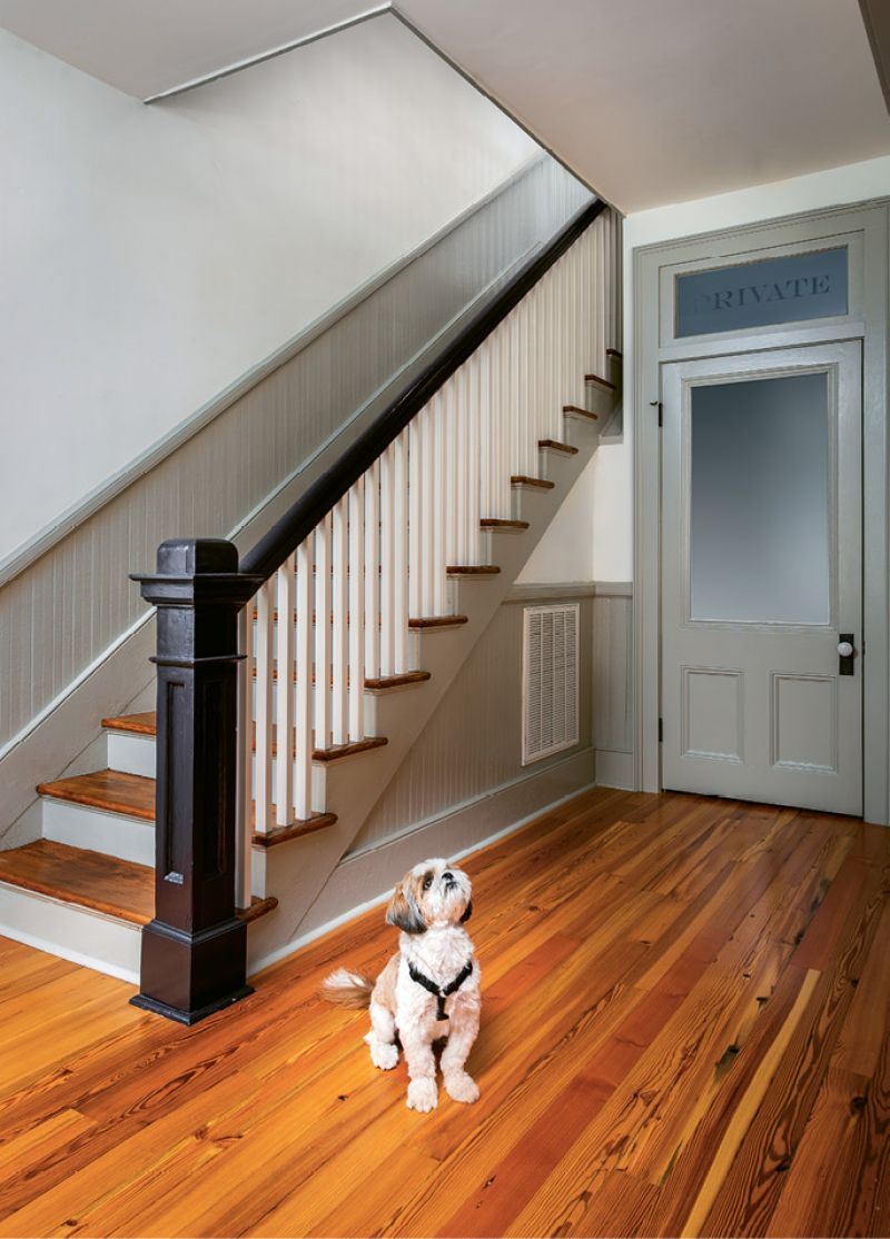 Oscar, the couple’s Shih Tzu, strikes a pose in front of the powder room.