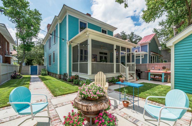 A single-story screened-in porch was added to the footprint. The Ellsworths love entertaining, and their fire pit—which is topped with a slice of petrified wood when not in use—is the centerpiece of frequent backyard gatherings.