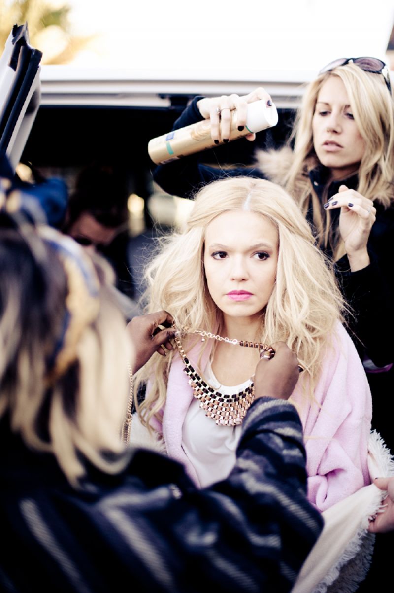 Style director Ayoka Lucas selects accessories, while Ashley Brook Perryman tames the model’s tresses.