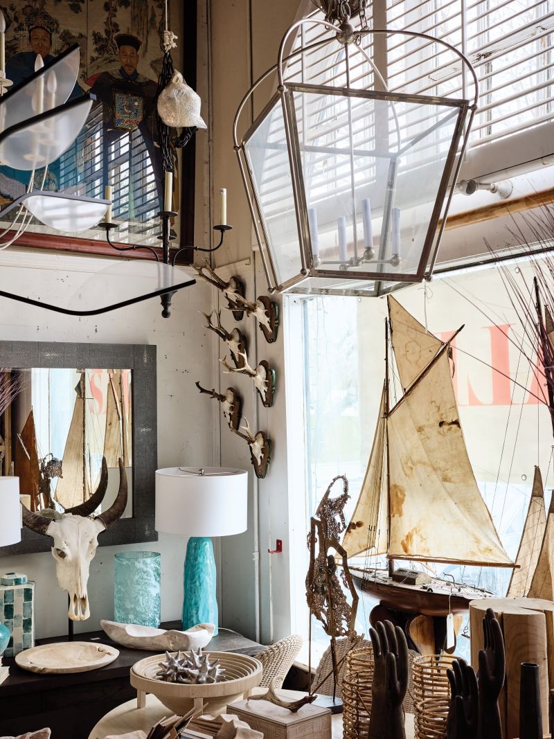 A window of lamps, lights, and boats inside English Country Home, Bridgehampton.