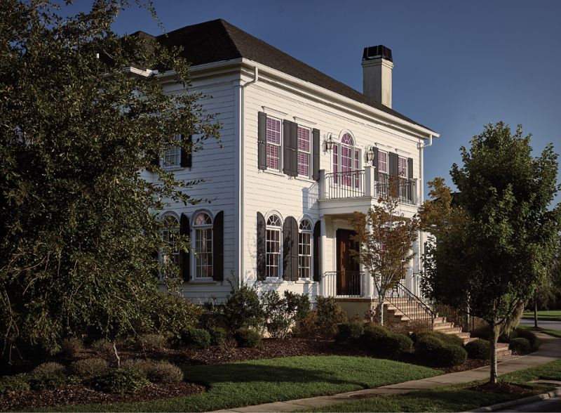 Designer Michael Mitchell merged antiques with modern art and lively color to transform this traditional Daniel Island home.